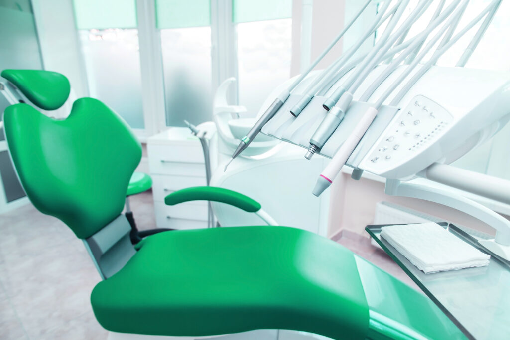 Modern green dental chair and equipment in a practice ready for valuation by Otten-Rey Dental Sales.
