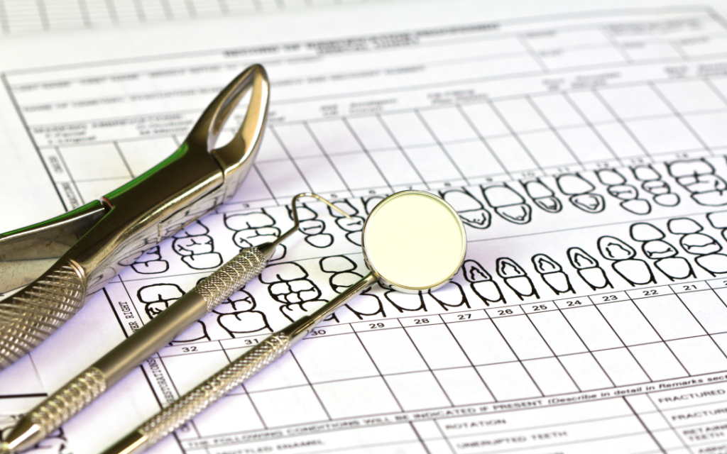 Dental tools placed on patient chart during practice appraisal evaluation