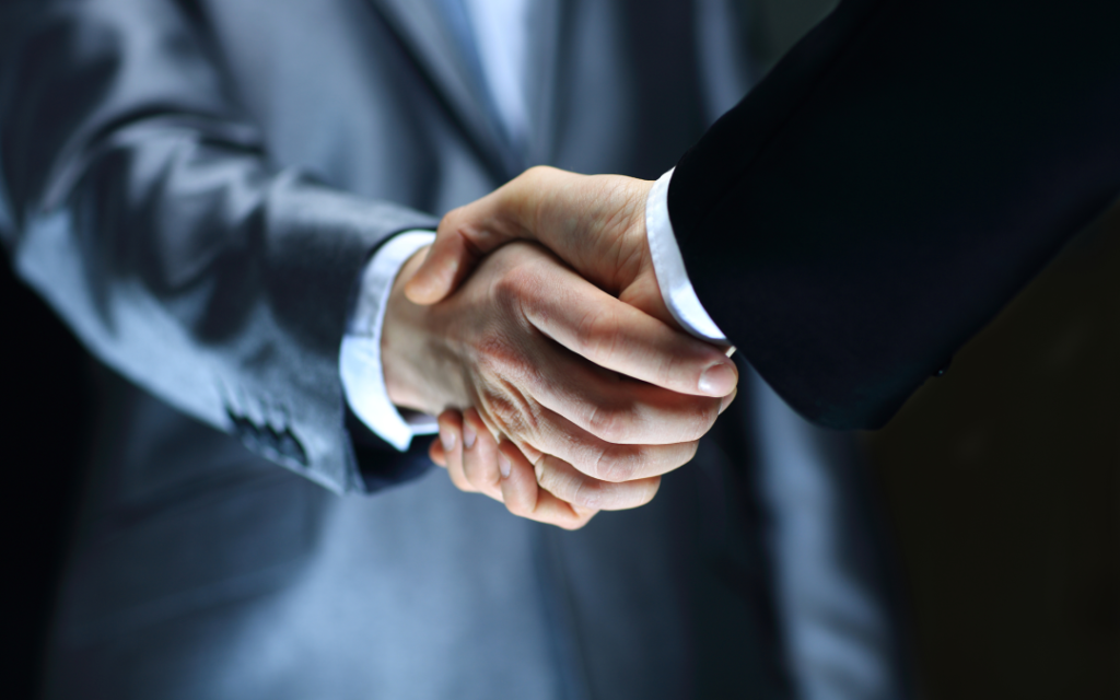 Successful dental practice sale finalized with handshake in St. Louis